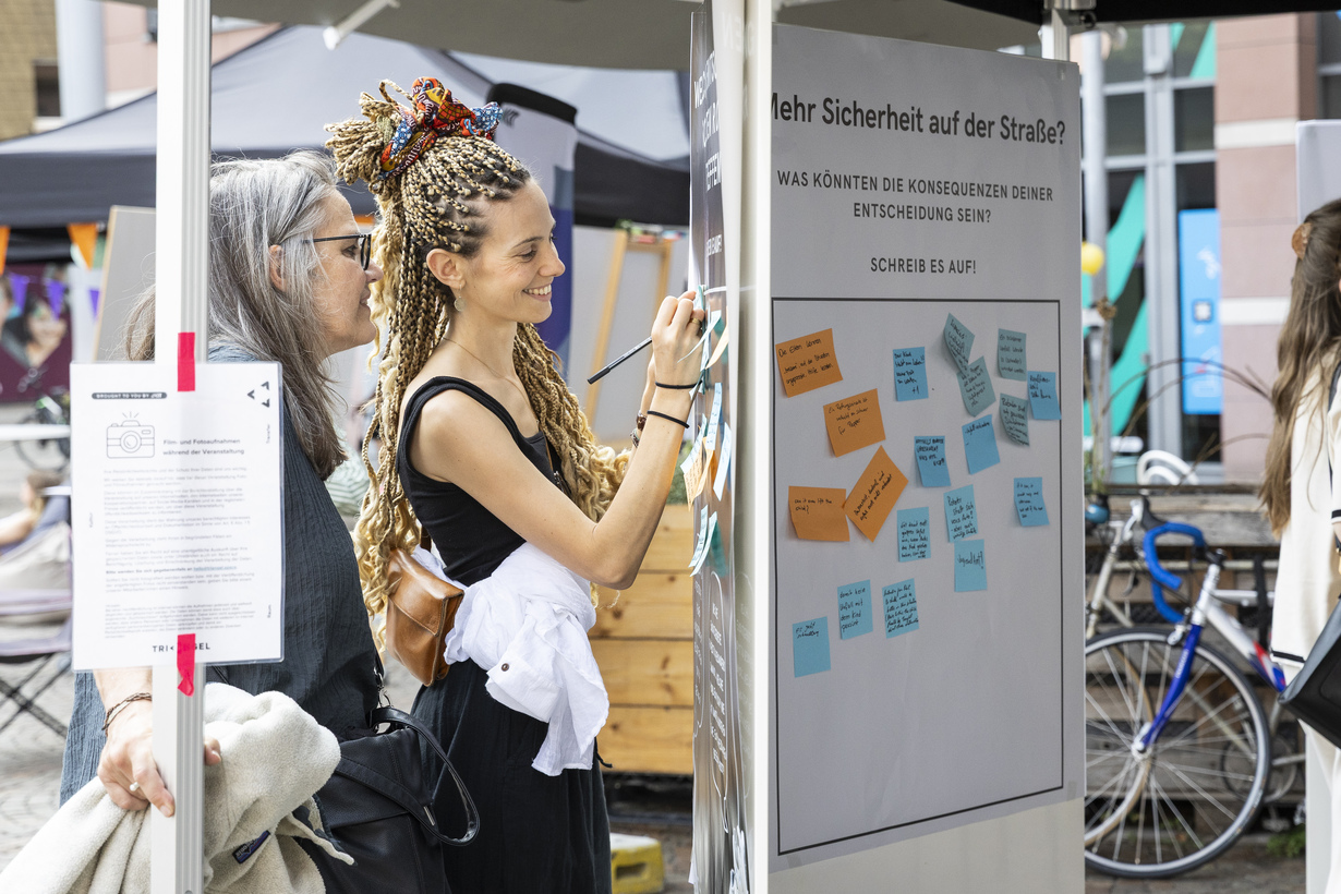  Eine Frau, die etwas auf einen Zettel schreibt